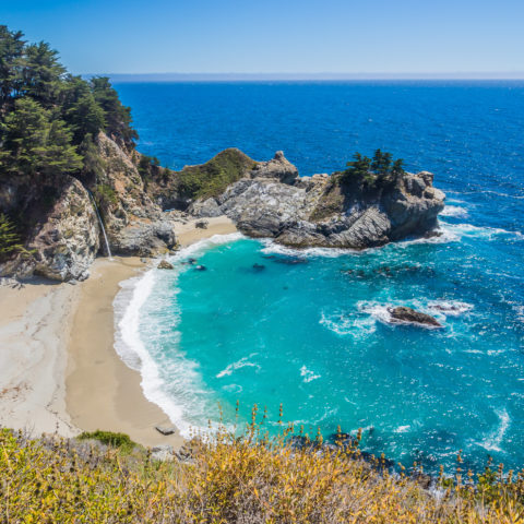 McWay Falls and the bright blue Pacific Ocean at Julia Pfeiffer Burns State Park, one of the best hikes in Big Sur, CA