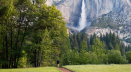 Man Walking on Path infront of Upper Yosemite Fall