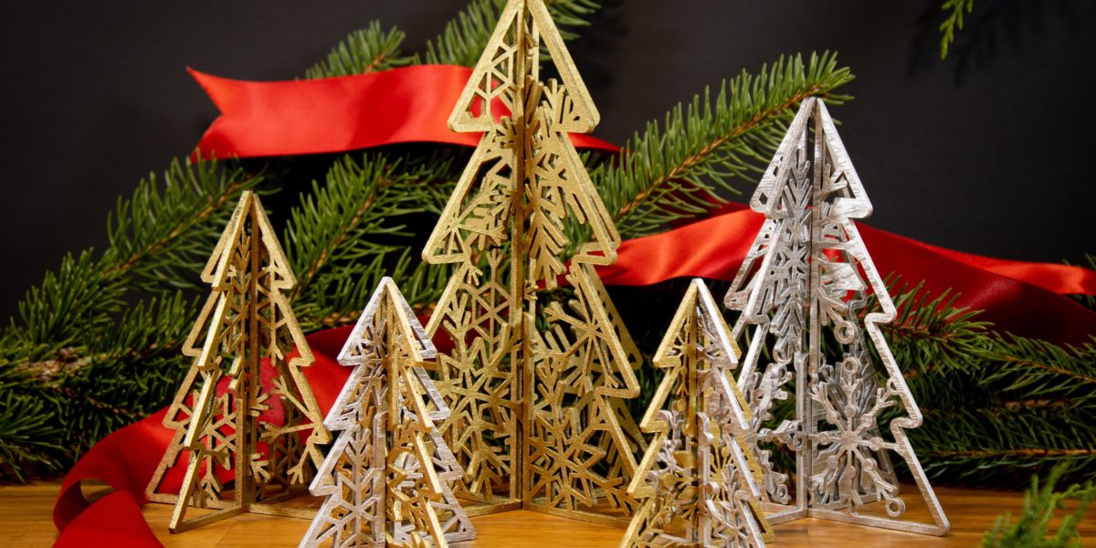 gold and silver wooden trees with carved snowflakes