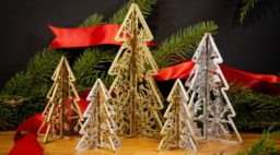 gold and silver wooden trees with carved snowflakes