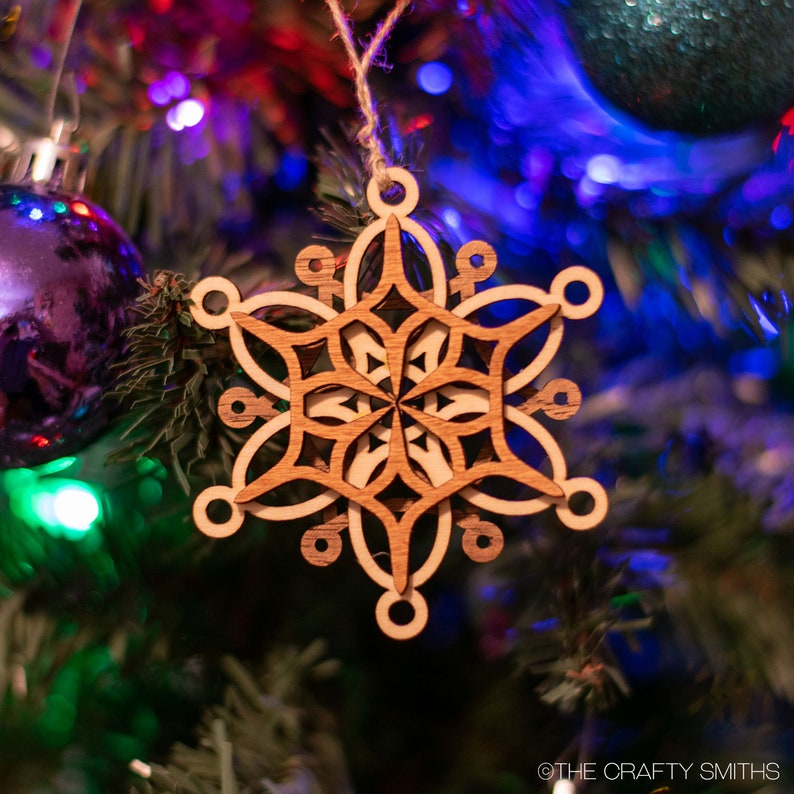 layered wood snowflake ornament on tree