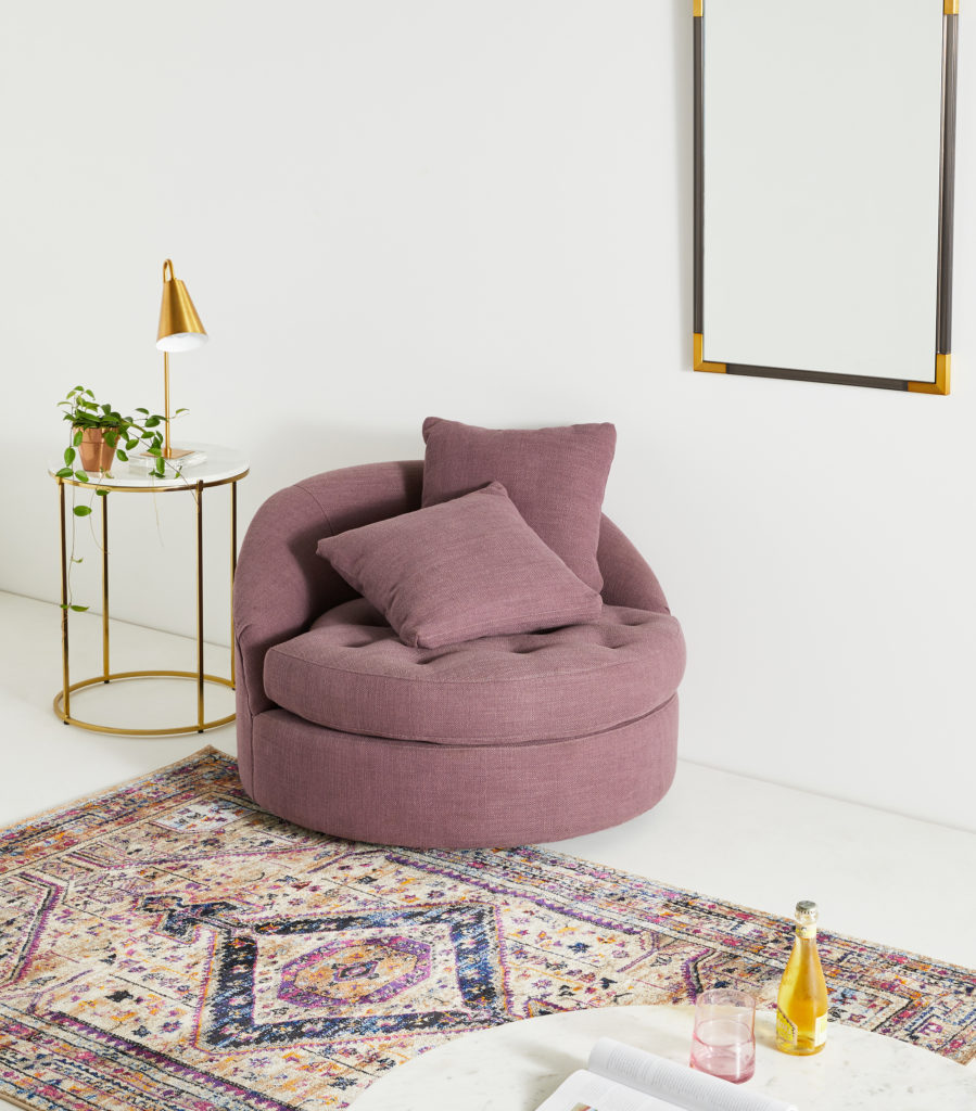 Mauve swivel chair by Anthropologie in living room