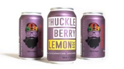 three cans of 503 Distilling i'm your huckleberry lemonade with two facing backwards and one facing forward on a white background.