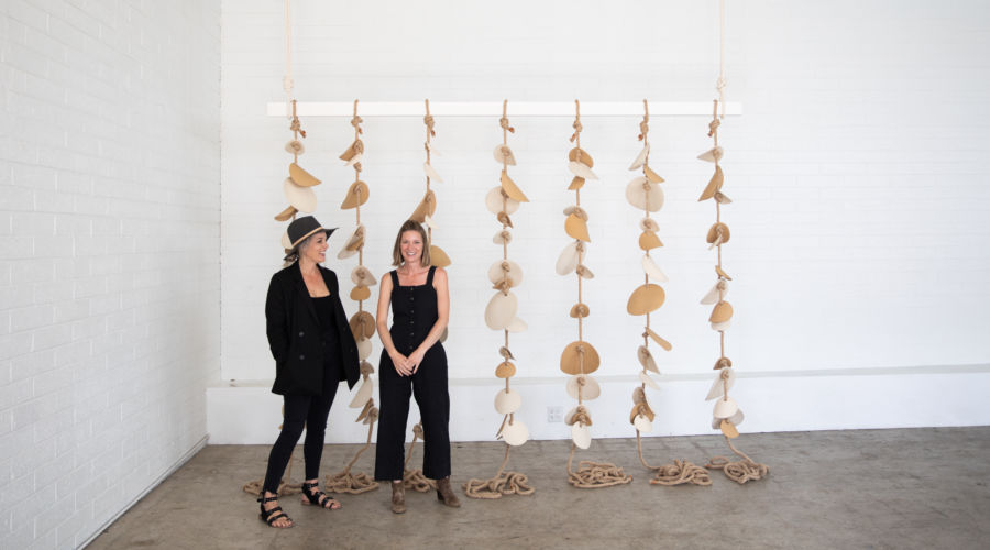 Alexis Garrett and Nicole Novena in front of their collaboration, Chime