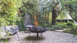 A round gravel patio, wrapped in pittosporum “Silver Sheen,” is a private nook off the master bedroom.