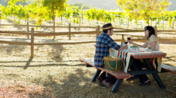 Couple picnicing under the oaks at Hahn Estate in Monterey Wine Country