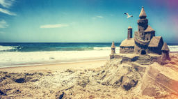 Sand castle on the beach seagull in background