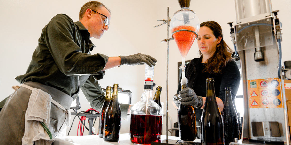 Carboniste winemakers bottling sparkling red wine