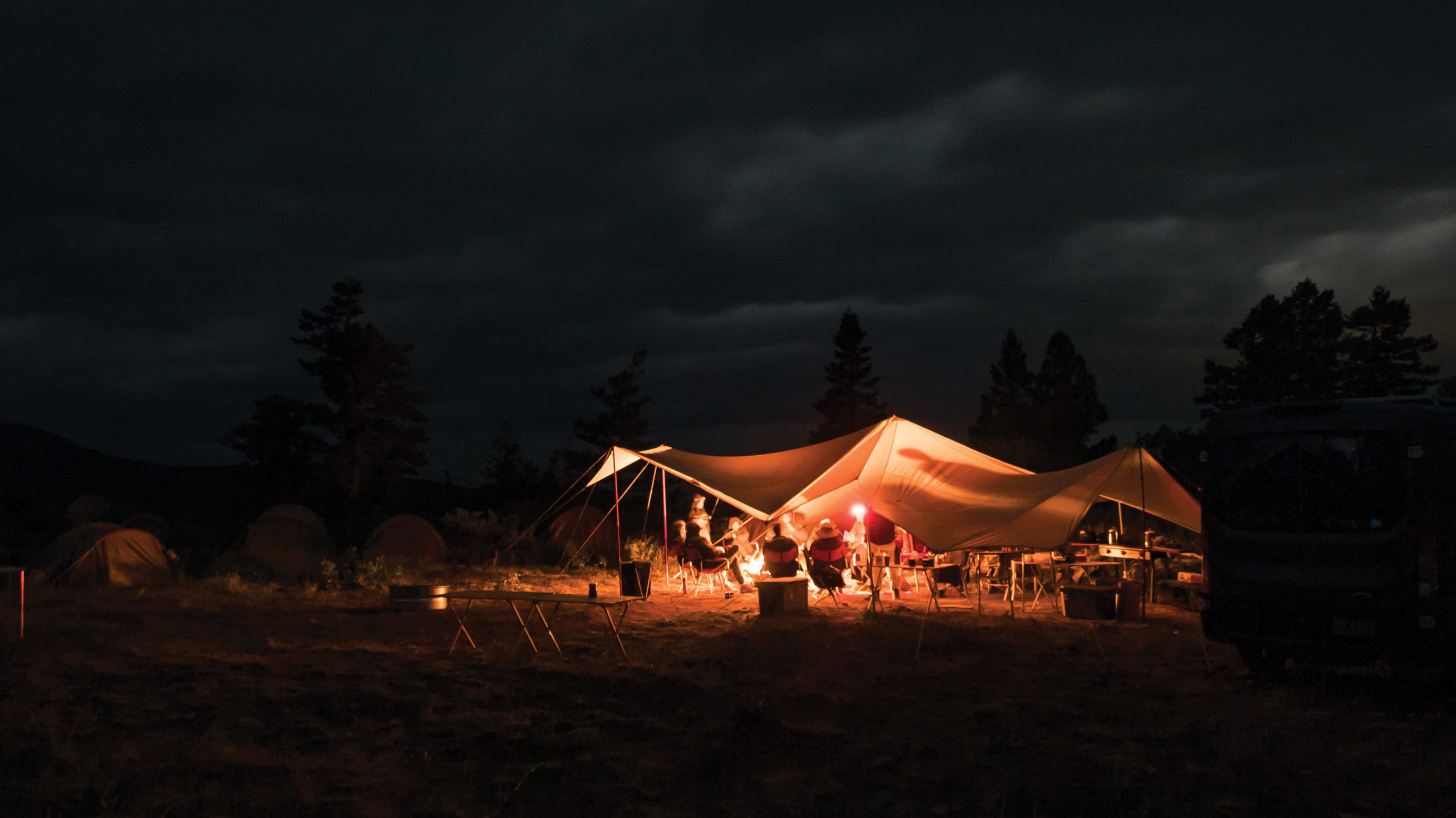 Camp tent setup at night