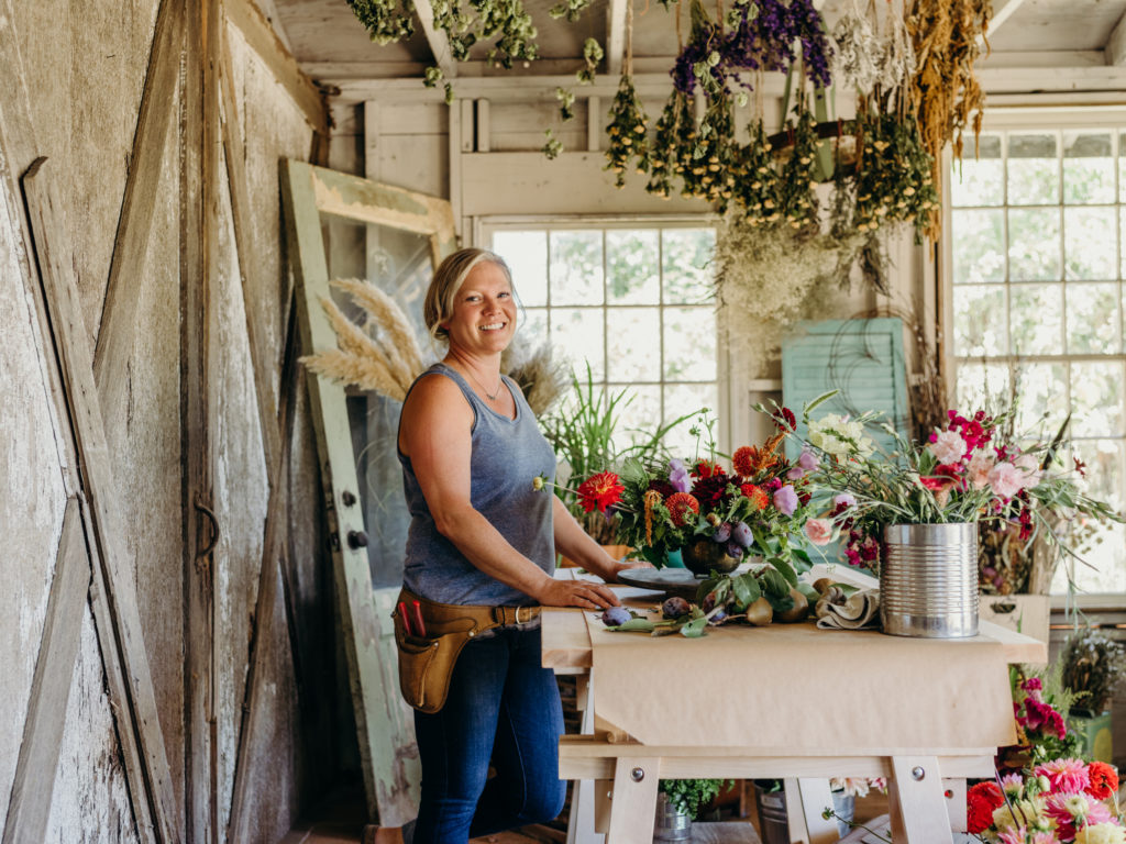 Beth Syphers arranges flowers in her studio, harvested from her farm.