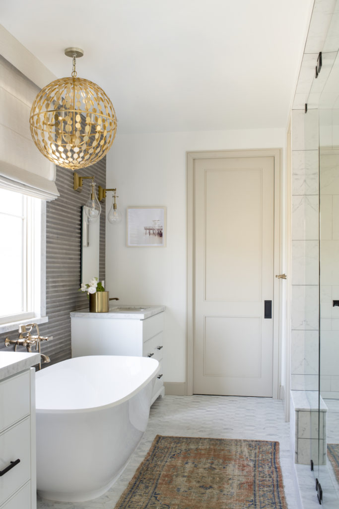 Manhattan Beach home tour by HMS Interiors with a tub from Victoria & Albert and brassware from Newport Brass