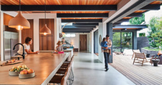 Newport Beach home kitchen with stools, beams, indoor/outdoor space