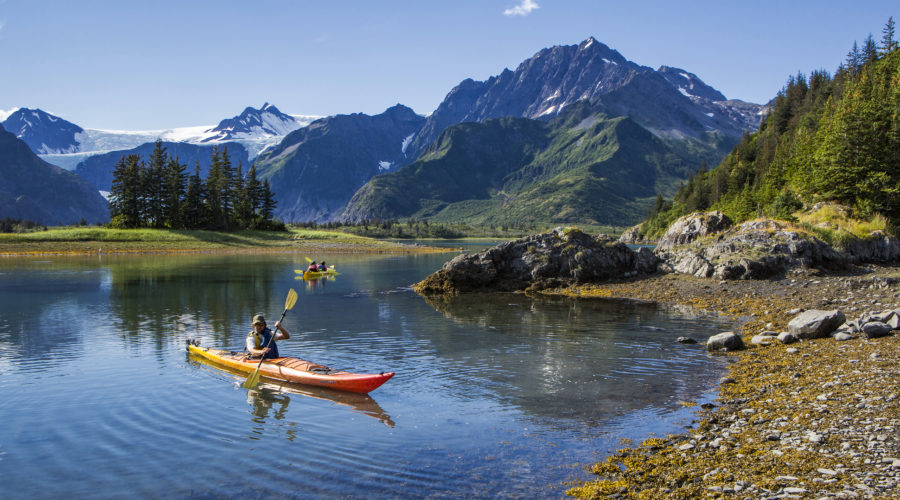 Kayakers near mountain shores