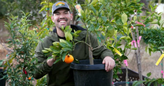 Kevin Espiritu with citrus tree