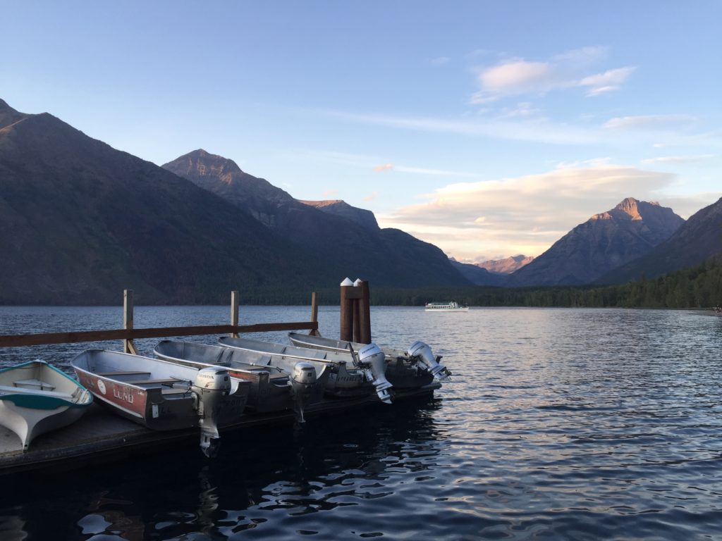 Boats on dock mountains behind