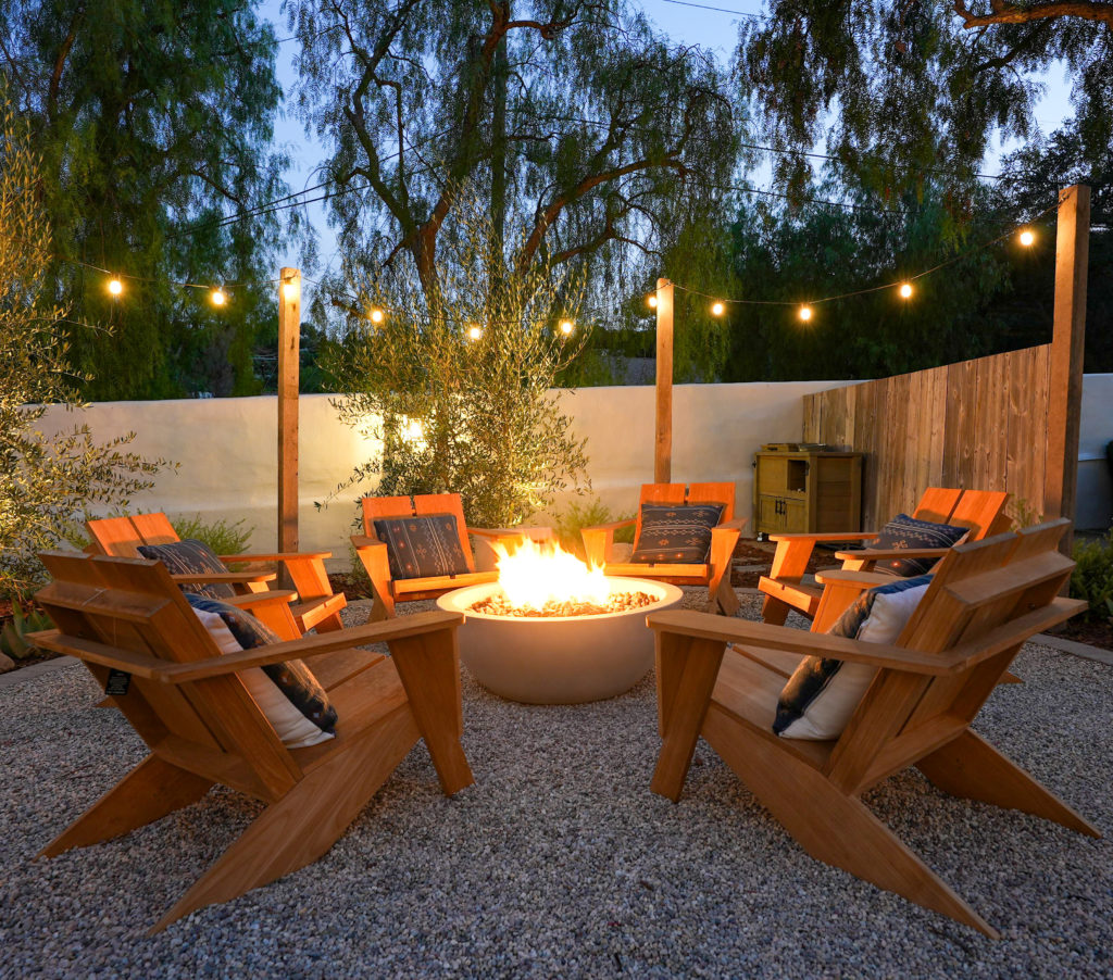Garden lighting at night with adirondack chairs