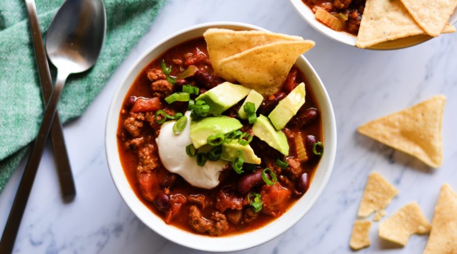 Mom's Chili by Dustin Harder shown on marble background with chips and other ingredients.