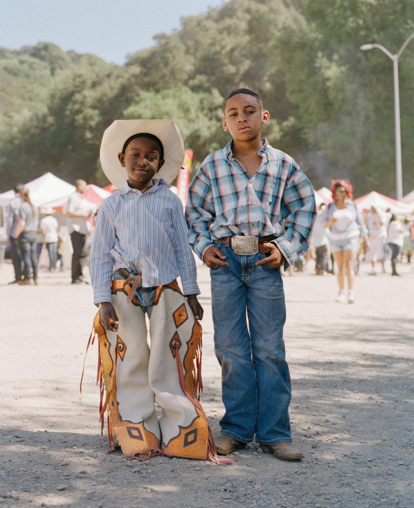 Two young cowboys attend Bill Pickett Rodeo
