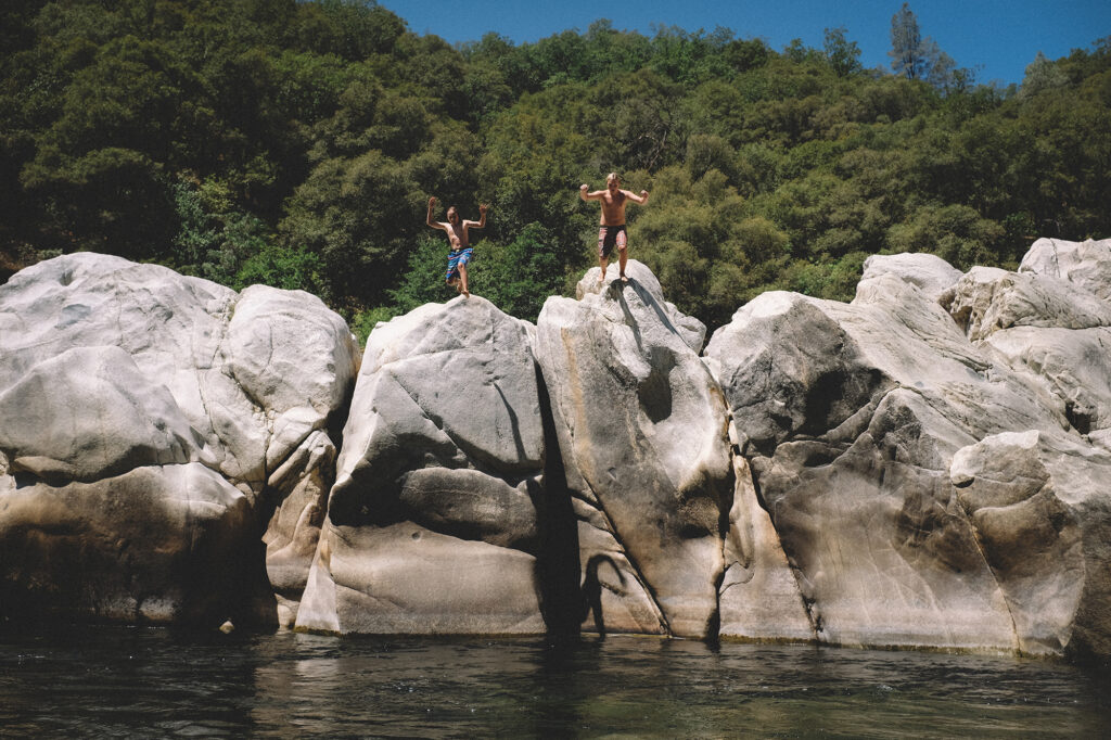 Two Boys Jump from Boulders at the Yuba River