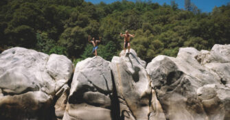 Two Boys Jump from Boulders at the Yuba River