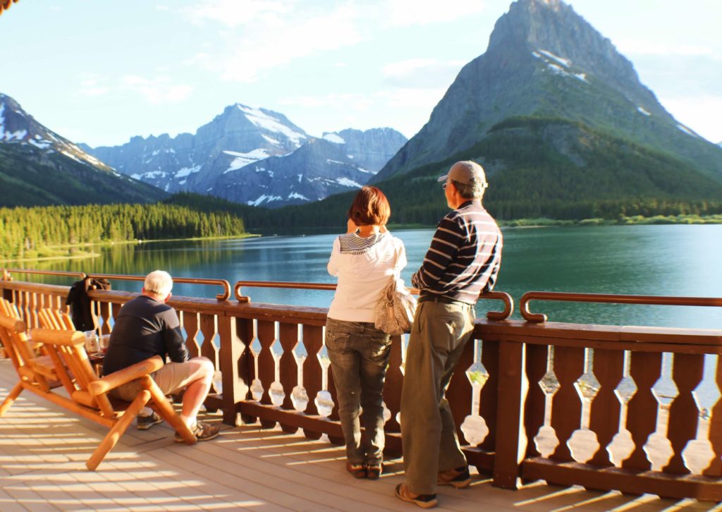 couple on porch looking at lake and mountains
