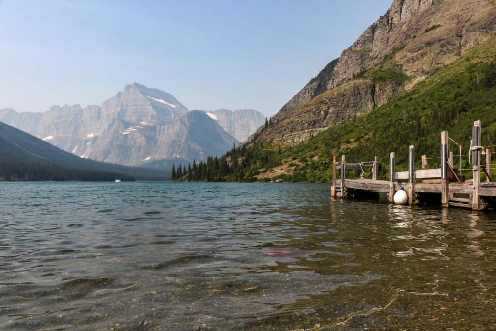 boat dock on lake mountains in the background