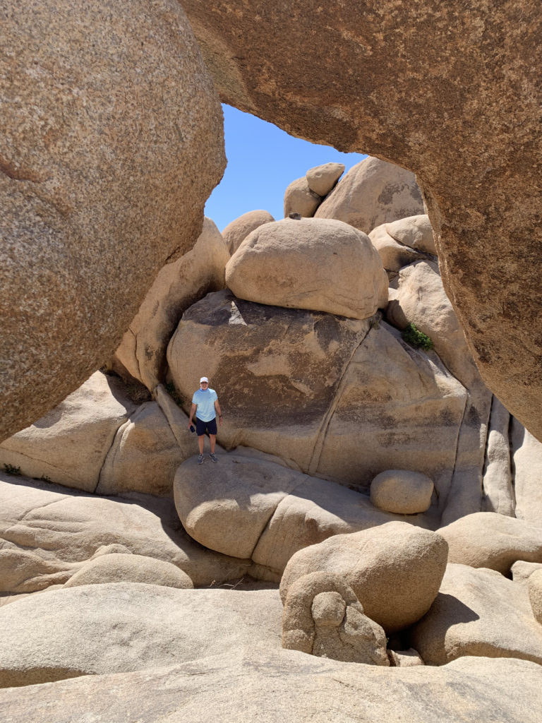 visitor at Arch Rock Joshua Tree National Park