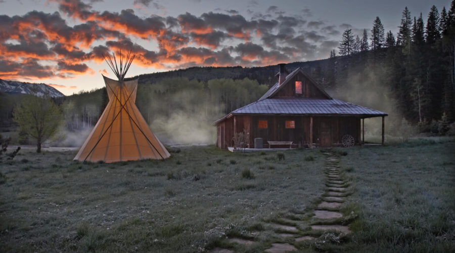 Cozy cabins in front of springs with a teepee at Dunton Hot Springs