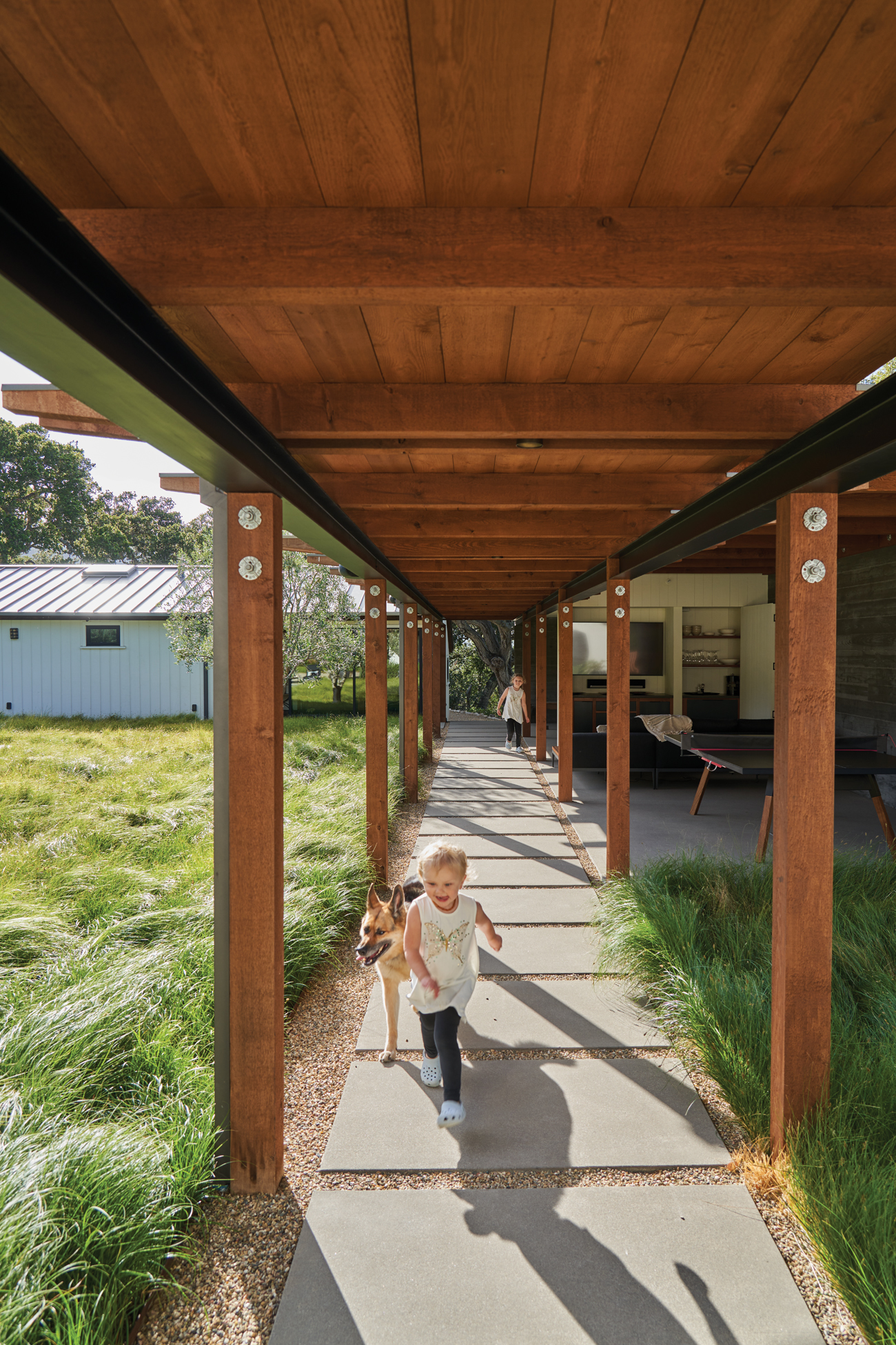 Child Walking Through Covered Walkway in Carmel California Ranch