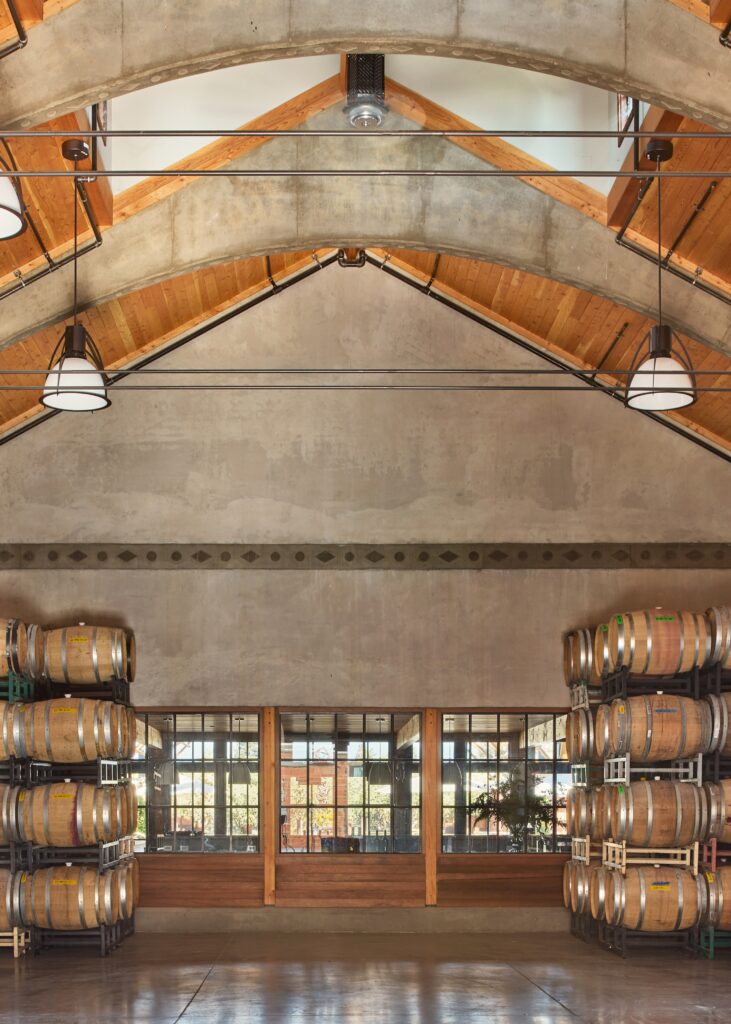 A room at a winery with stacks of wine barrels