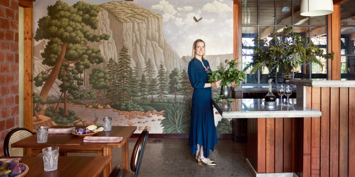 The interior of a winery, featuring a mural of a forest landscape