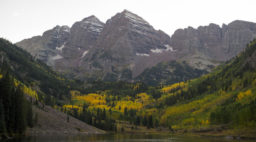 Maroon Bells, seen in front of a lake and with a snow-capped peak, one of the best fall hikes in the West
