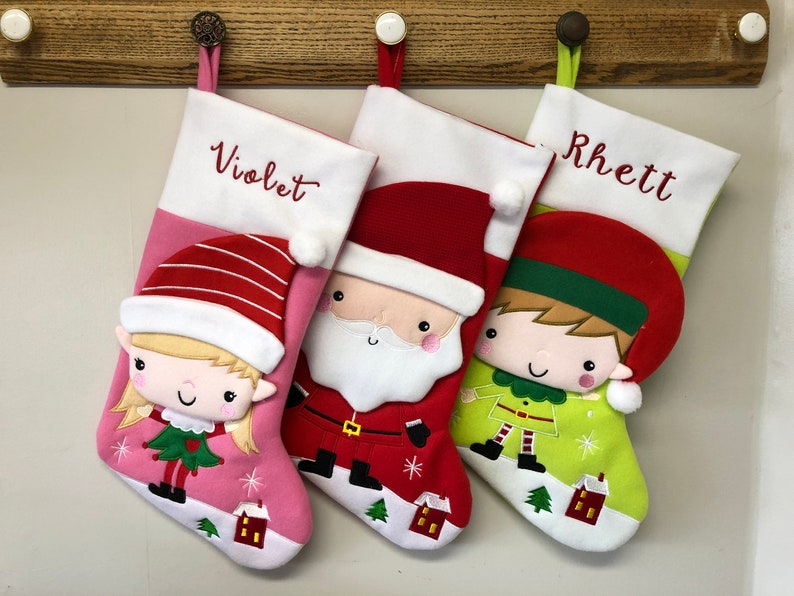stockings with cartoon girl and boy elf and santa