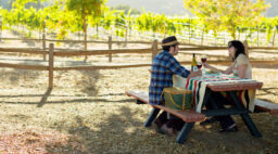 Couple picnicing under the oaks at Hahn Estate in Monterey Wine Country