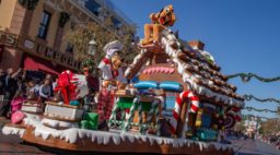 goofy and pluto on gingerbread float in disney holiday parade