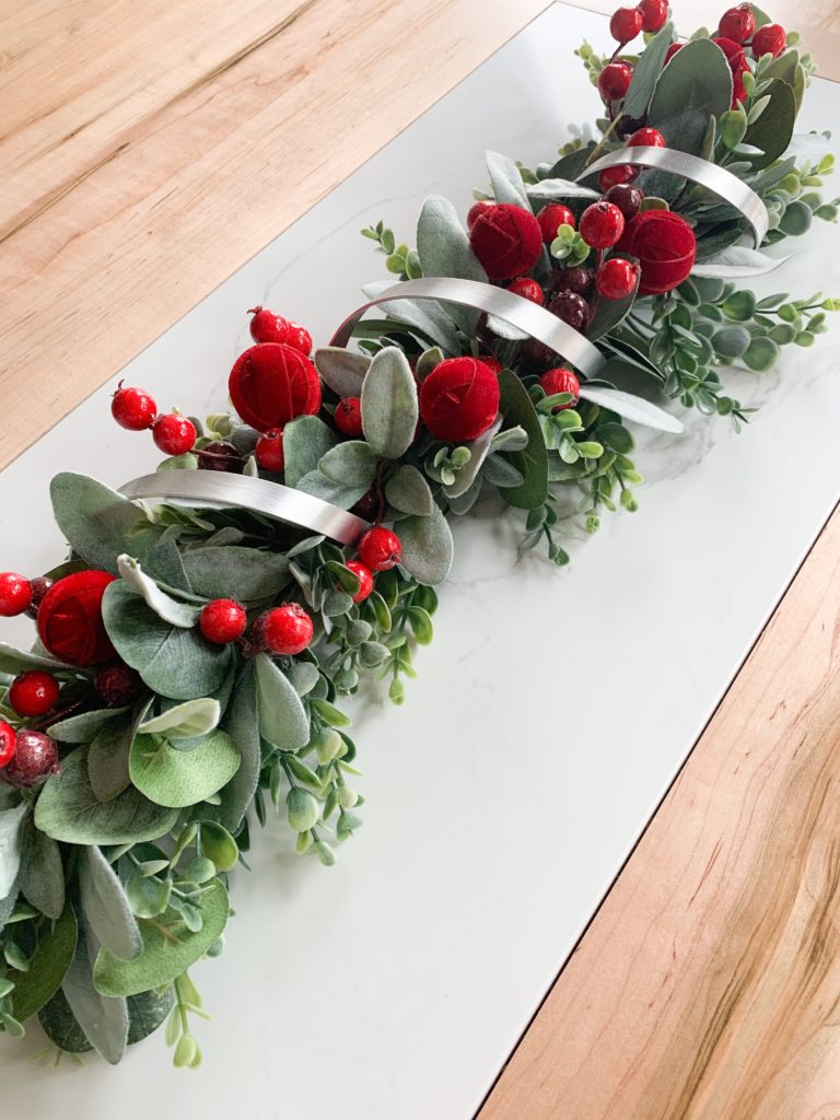 faux holly sprigs berries and spiral metal centerpiece