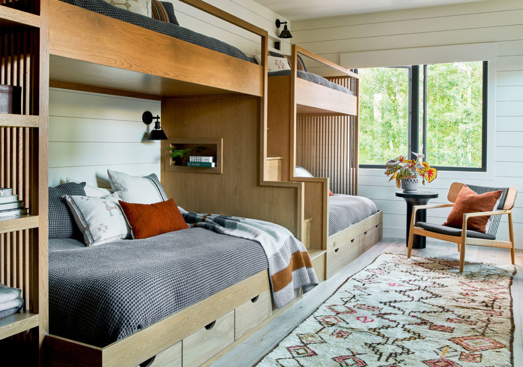 Bunkroom/bedroom with white paneling in Park City home