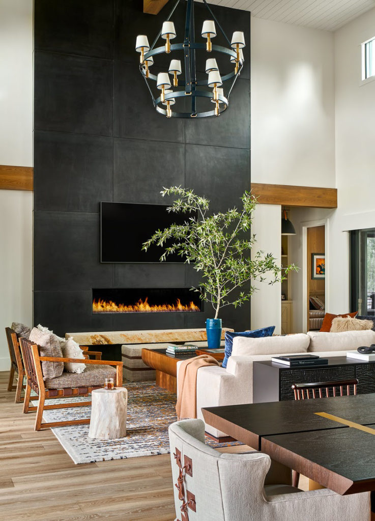 Living room in Park City with high ceilings and black fireplace