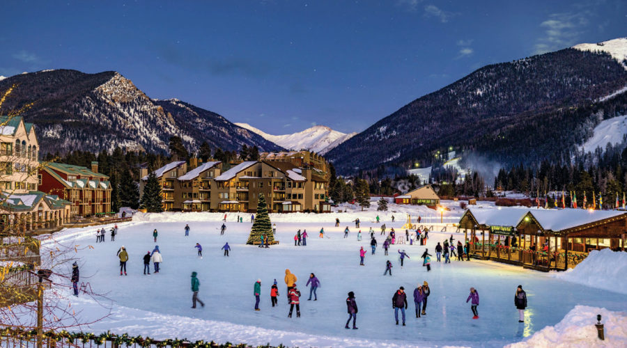 The ice skating rink at Keystone with skaters and a Christmas tree
