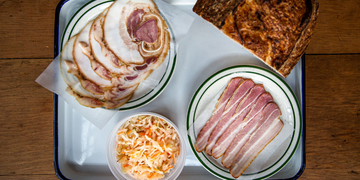 A platter of sliced meats and bread at Kachka Lavka