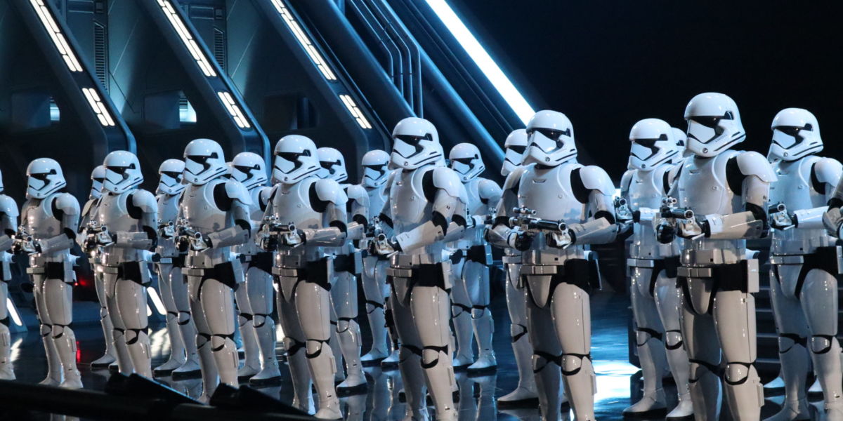 Storm Troopers greet the captured members of the Resistances in a massive Star Destroyer hanger.