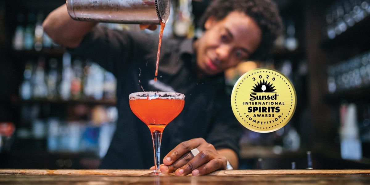 A bartender pouring a cocktail, with the Sunset International Spirits Awards badge.