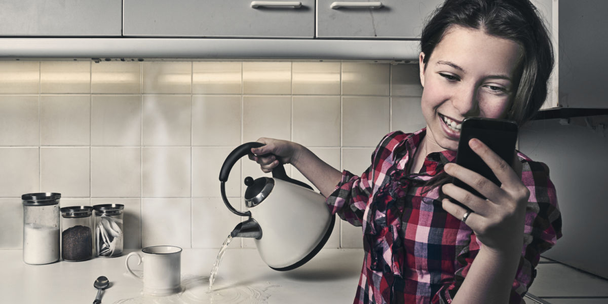 Teenage Girl on Phone While Pouring Hot Water