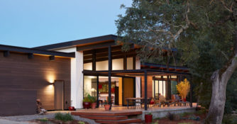 Klopf Architecture in Sacramento designed this single-story modern house with intense summer heat in mind, building a patio under the shade of a mature oak with a large overhang.