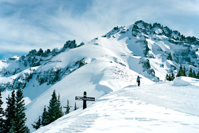 Man hiking along ridgeline with skis at Telluride