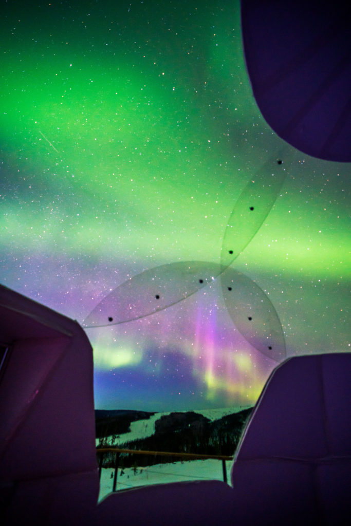 View of northern lights from inside a dome room at Borealis Basecamp in Fairbanks