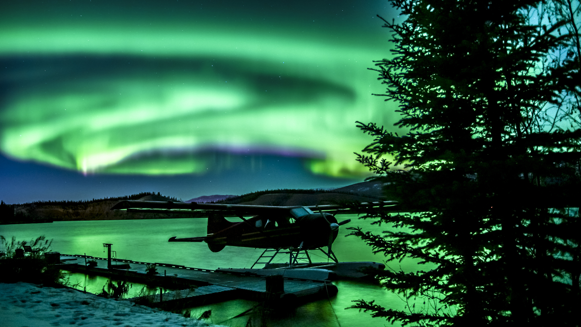 Bush plane on a lake under the northern lights in Yellowknife