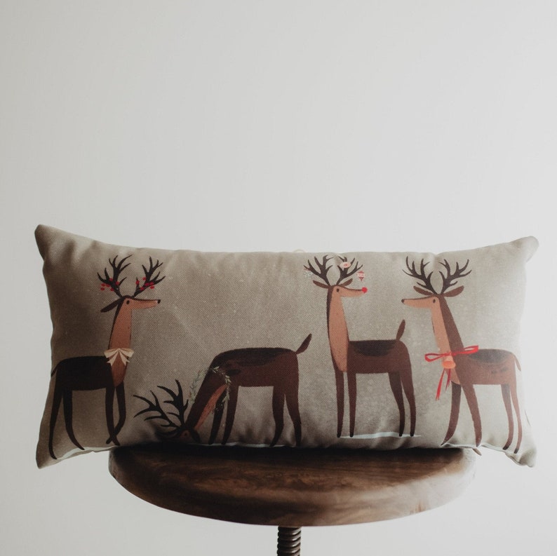 pillow cover with four reindeer with bows berries and ornaments