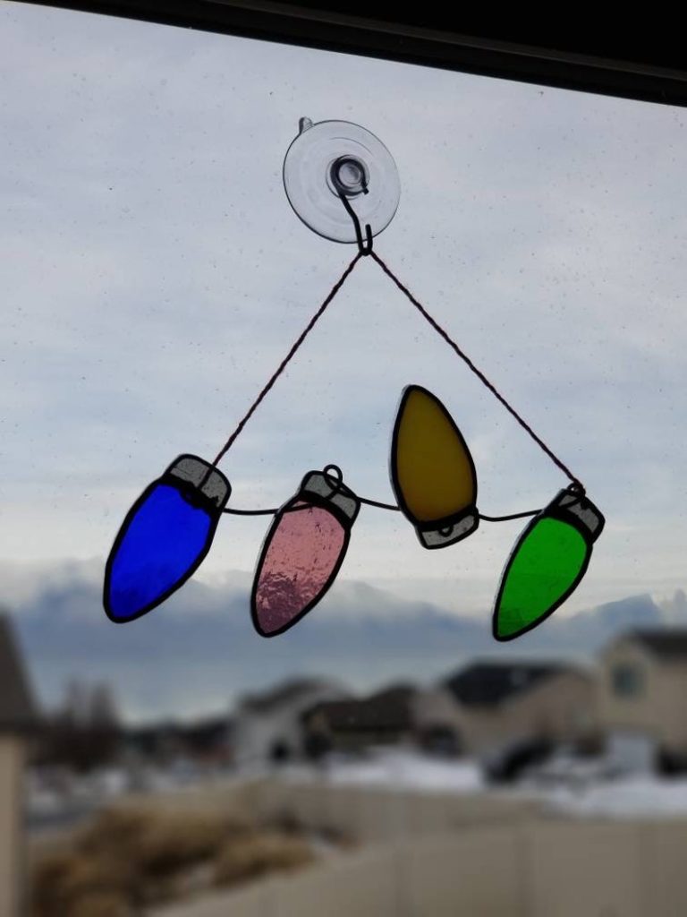 blue pink yellow and green glass lights hanging