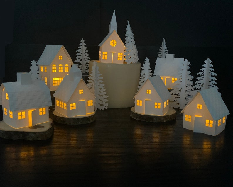 six white lit-up buildings with trees